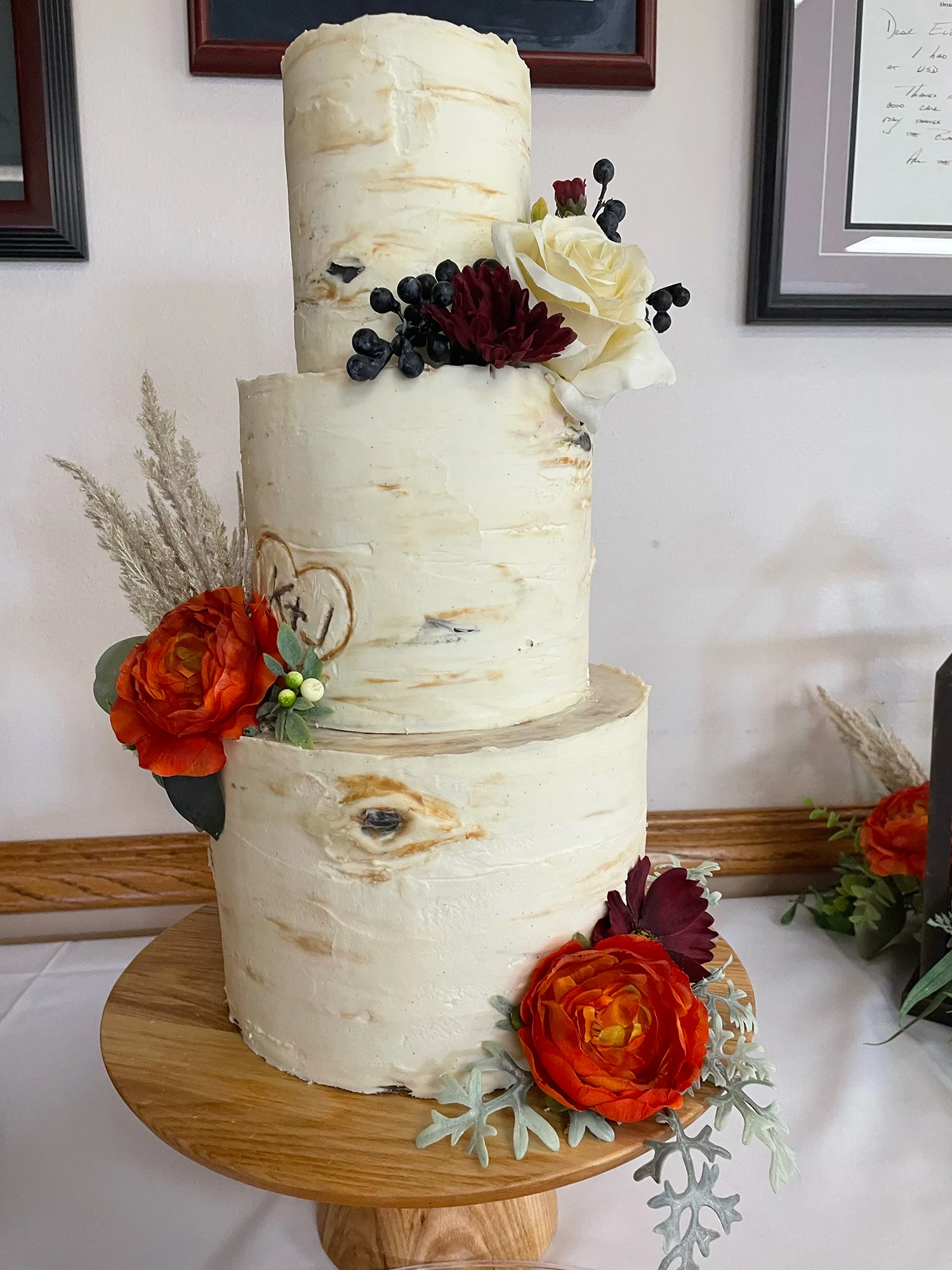 Beautiful rustic wedding cake with floral decorations